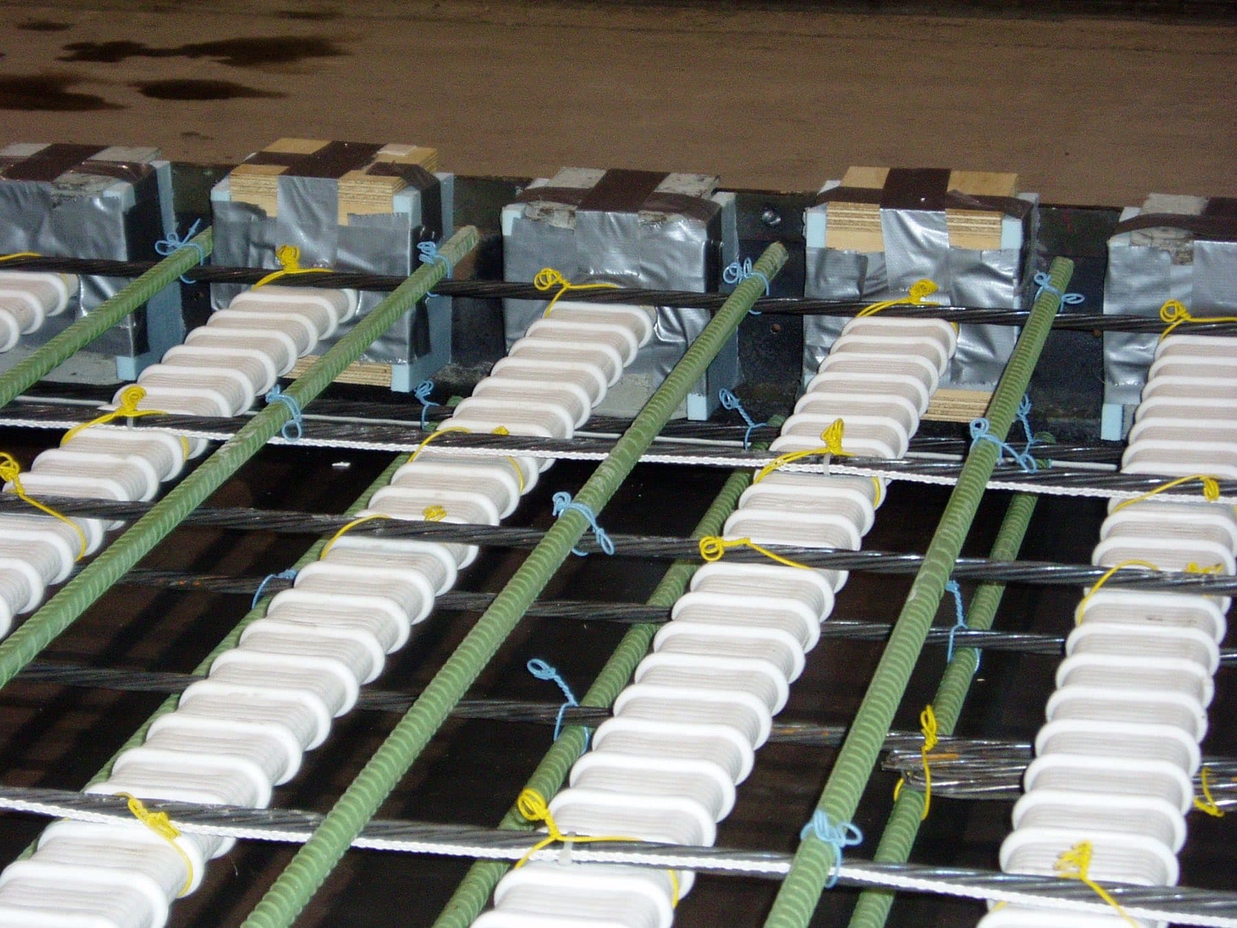 Shear pockets and post-tensioning ducts in a full-depth precast bridge deck panel