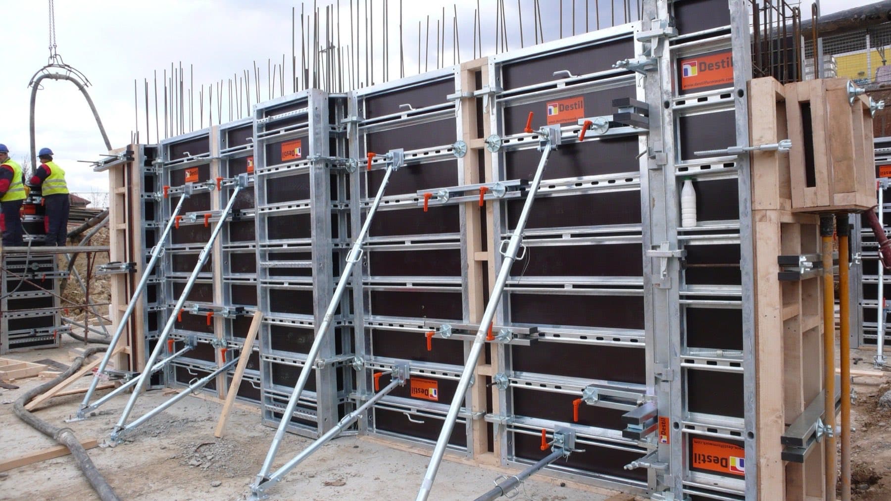 Steel wall formwork panels braced with props over reinforcement