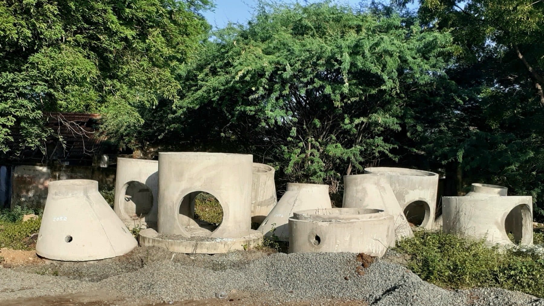 Precast concrete manhole risers and cone sections in a storage yard